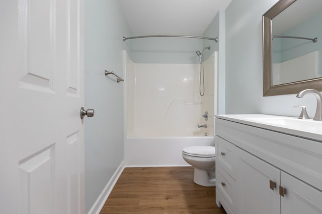 full bathroom with hardwood / wood-style flooring, vanity, toilet, and shower / tub combination