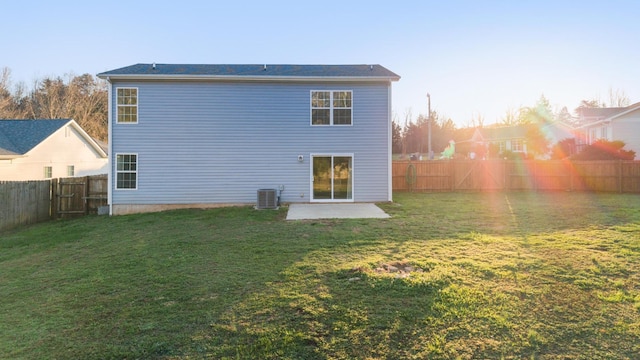 rear view of property featuring a yard, cooling unit, and a patio area