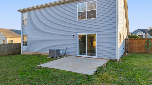 rear view of house with a lawn, a patio area, and cooling unit