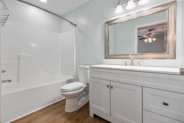 full bathroom with hardwood / wood-style floors, vanity, ceiling fan, toilet, and tub / shower combination