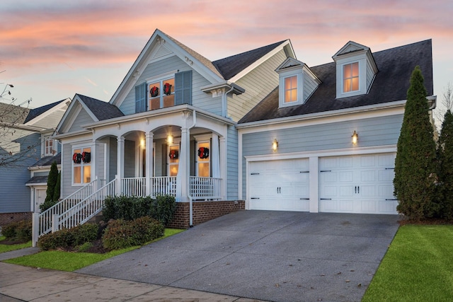 view of front of property featuring a porch and a garage