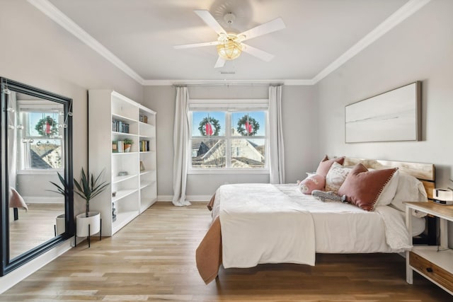 bedroom with light hardwood / wood-style flooring, ceiling fan, and ornamental molding