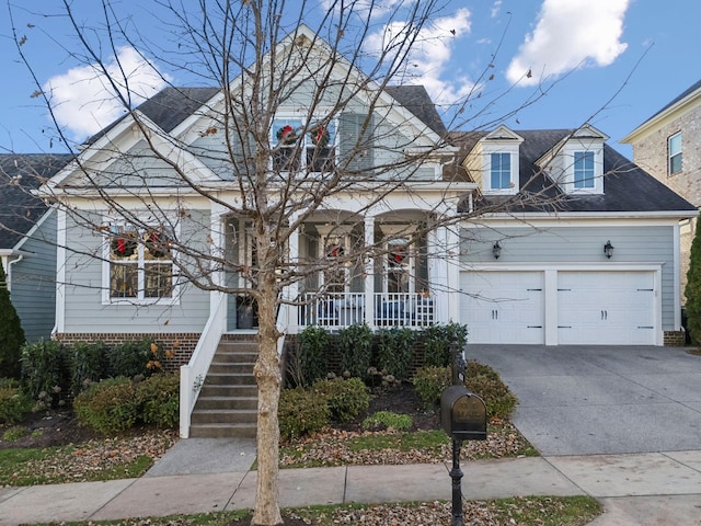 view of front of property with a garage and covered porch