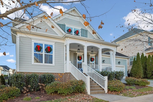 view of front facade featuring covered porch and a garage