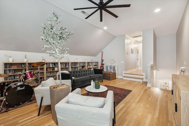 living room featuring ceiling fan, hardwood / wood-style floors, and lofted ceiling