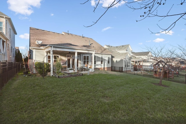 rear view of house featuring a patio area and a lawn