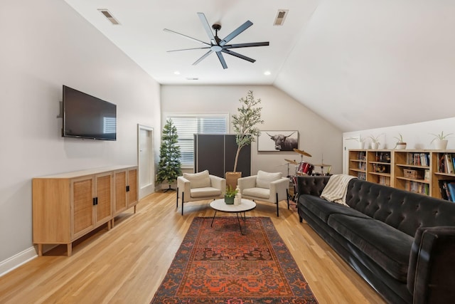 living room featuring light hardwood / wood-style floors, ceiling fan, and lofted ceiling