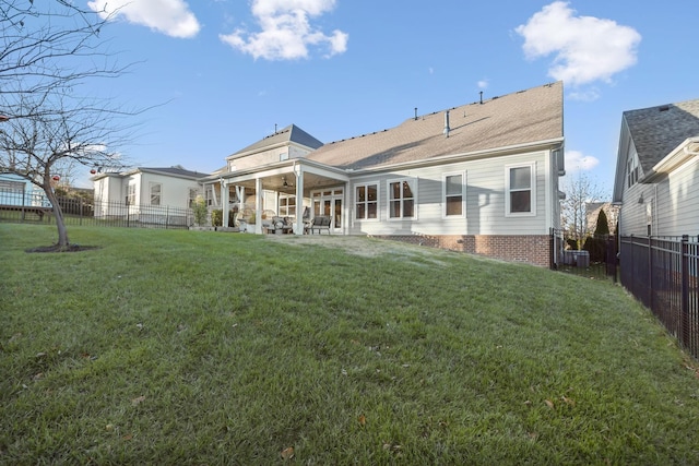 back of house with a yard, ceiling fan, and a patio area