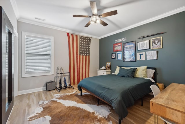 bedroom with light wood-type flooring, ceiling fan, and ornamental molding