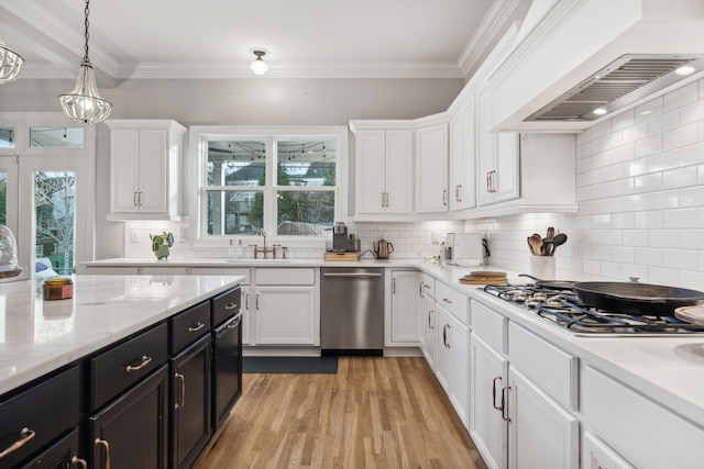 kitchen featuring hanging light fixtures, backsplash, appliances with stainless steel finishes, white cabinets, and custom exhaust hood