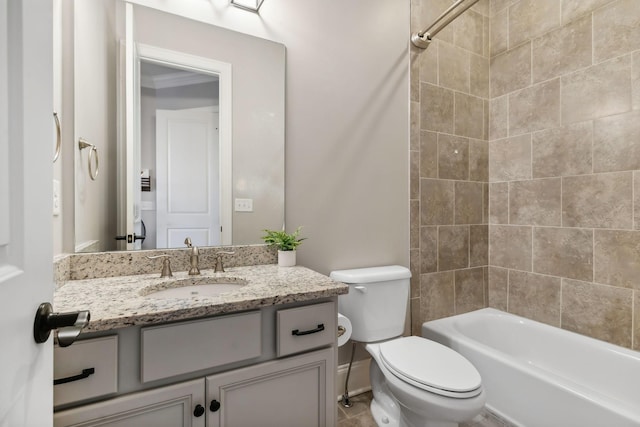 full bathroom with tiled shower / bath, vanity, and toilet