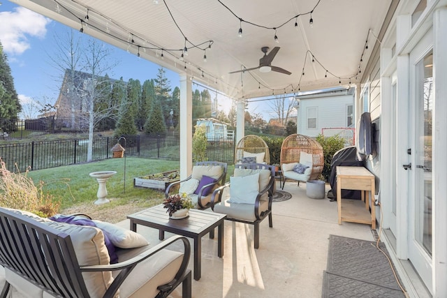 sunroom featuring ceiling fan