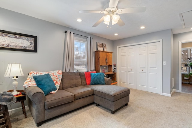 carpeted living room with ceiling fan