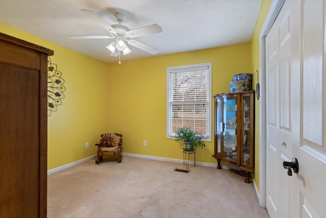 unfurnished room with ceiling fan and light carpet