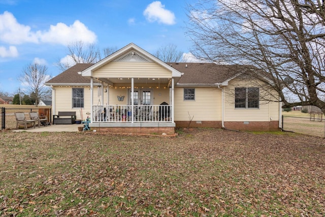 back of house featuring a yard, a patio, and a porch