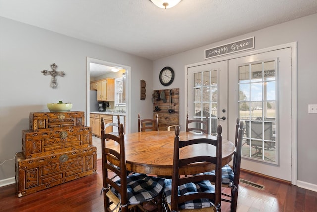 dining area with french doors and dark hardwood / wood-style floors