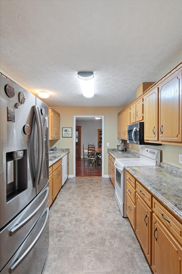 kitchen with stainless steel appliances and a textured ceiling