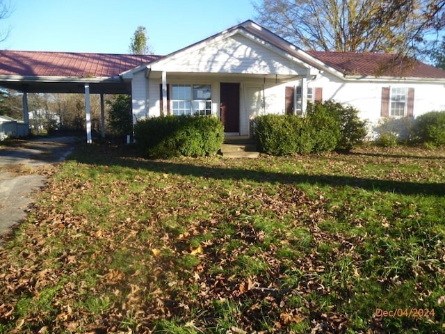 single story home featuring a front yard and a carport