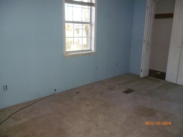 unfurnished bedroom featuring a closet and carpet floors