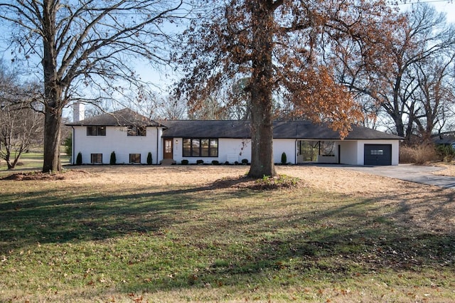 view of front of house with a garage and a front yard