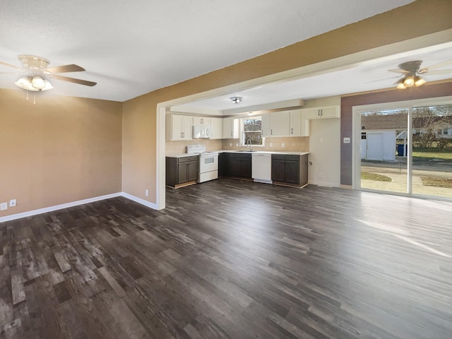 unfurnished living room with dark hardwood / wood-style flooring, ceiling fan, and sink