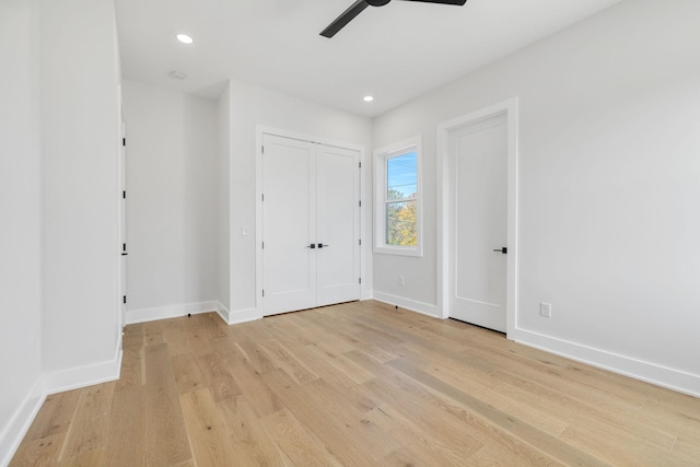 unfurnished bedroom featuring ceiling fan and light wood-type flooring