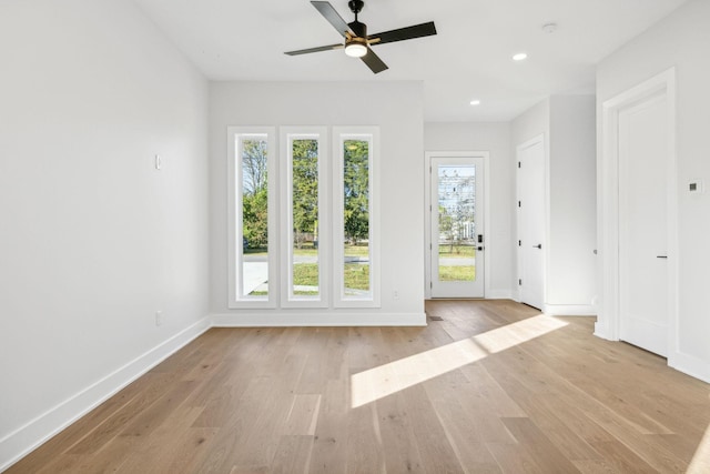 spare room featuring ceiling fan and light hardwood / wood-style floors