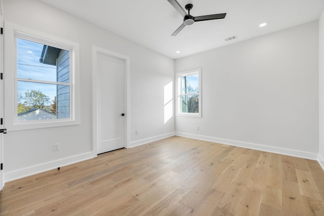 spare room featuring light hardwood / wood-style flooring and ceiling fan