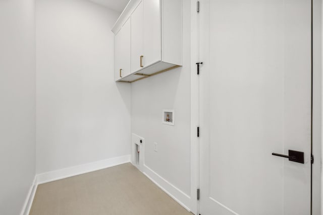 clothes washing area featuring washer hookup, hookup for an electric dryer, and cabinets