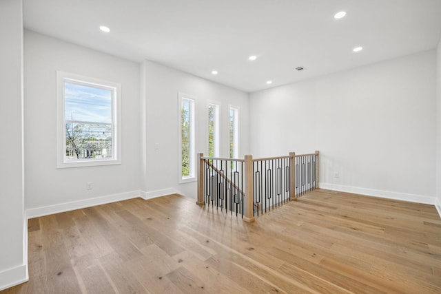 unfurnished room with light hardwood / wood-style floors