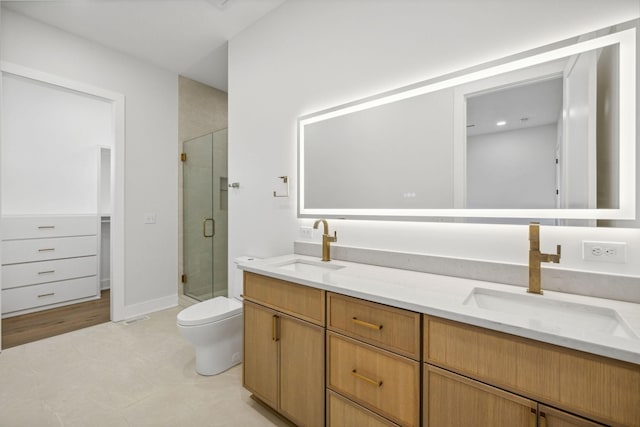 bathroom with vanity, an enclosed shower, and toilet