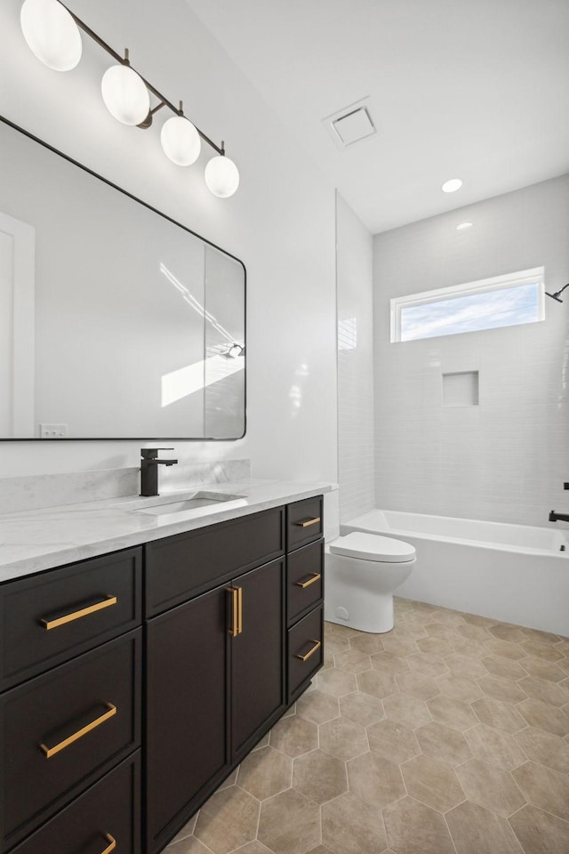 full bathroom with vanity, toilet, and tiled shower / bath