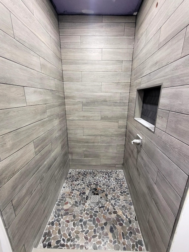 bathroom with a tile shower