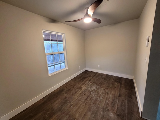 empty room featuring dark hardwood / wood-style flooring and ceiling fan