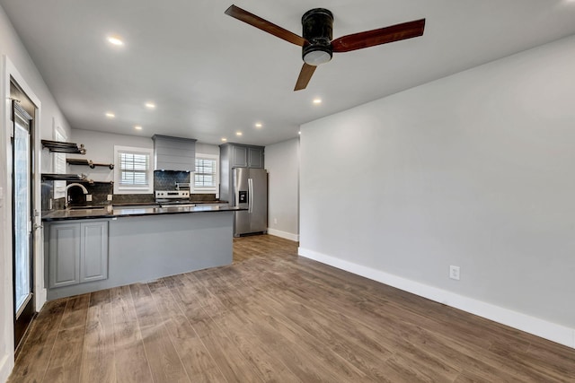 235 Union Ridge Rd, Wartrace, TN 37183 - kitchen featuring wood finished floors, dark countertops, appliances with stainless steel finishes, a sink, and open shelves