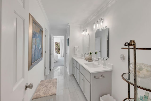 bathroom featuring crown molding, a sink, and double vanity