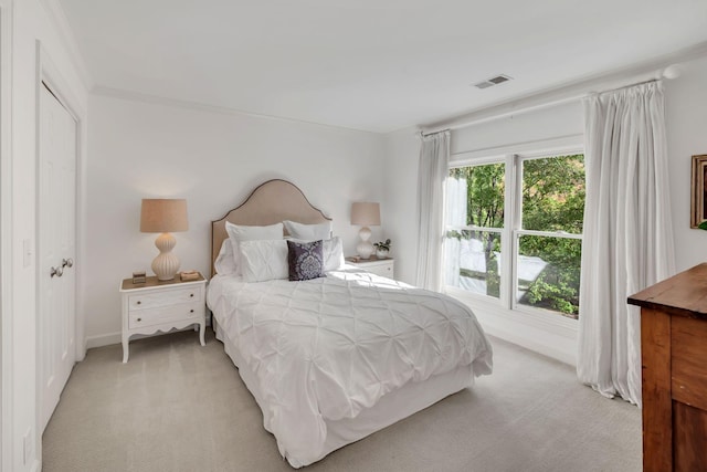 bedroom with light carpet and visible vents