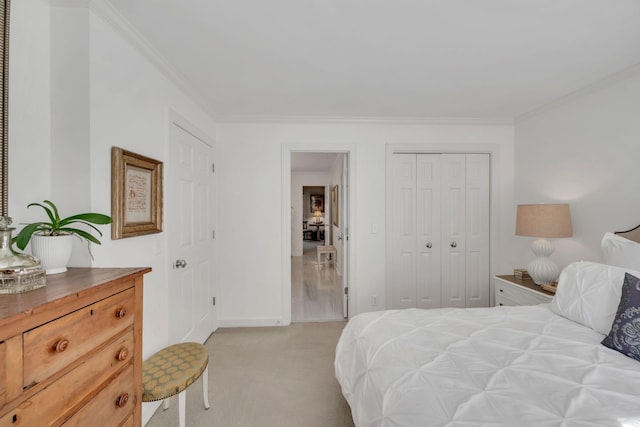 bedroom featuring light carpet, a closet, baseboards, and crown molding