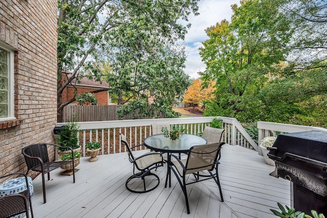 wooden deck with fence and outdoor dining area