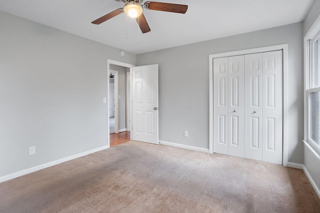 unfurnished bedroom with ceiling fan, light carpet, and a closet