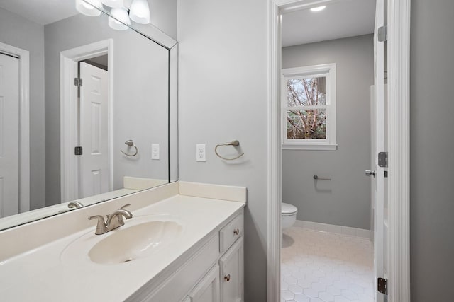 bathroom with tile patterned flooring, vanity, and toilet