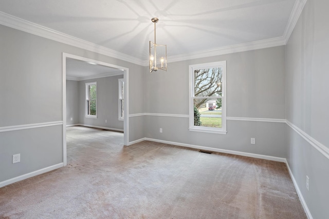 carpeted spare room featuring crown molding and a chandelier