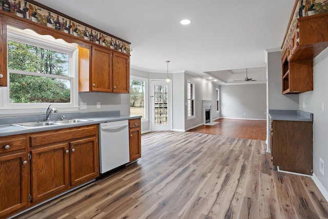 kitchen featuring pendant lighting, dishwasher, sink, crown molding, and ceiling fan