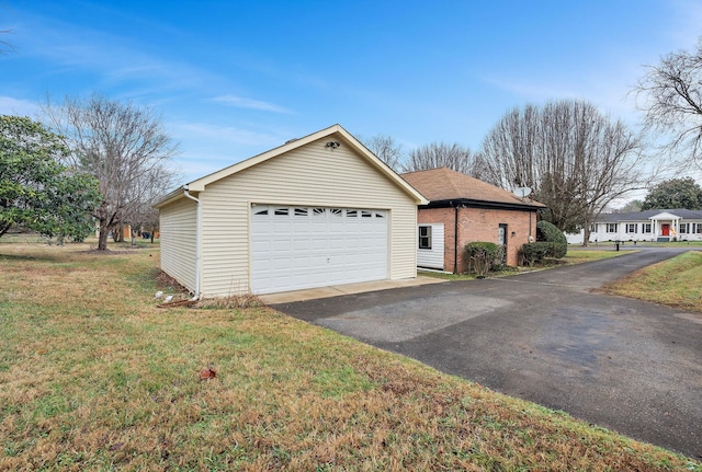 view of front of home with a front yard and a garage