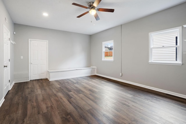 unfurnished room with dark hardwood / wood-style floors and ceiling fan