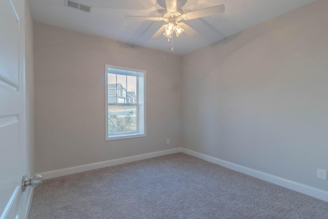 carpeted empty room featuring ceiling fan