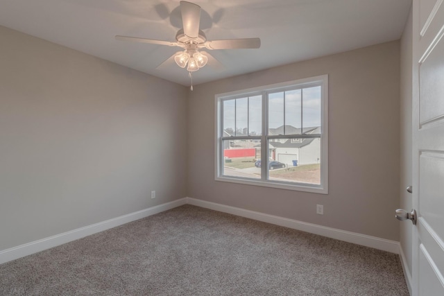 spare room featuring carpet flooring and ceiling fan