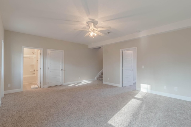 unfurnished room with light colored carpet and ceiling fan