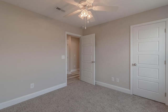 unfurnished bedroom with ceiling fan and light colored carpet