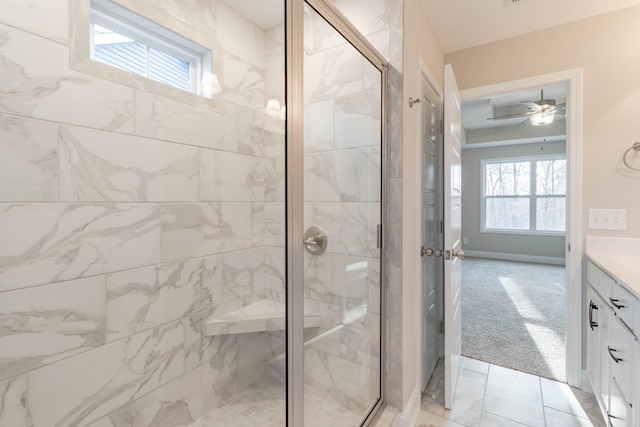 bathroom with ceiling fan, a shower with door, and vanity